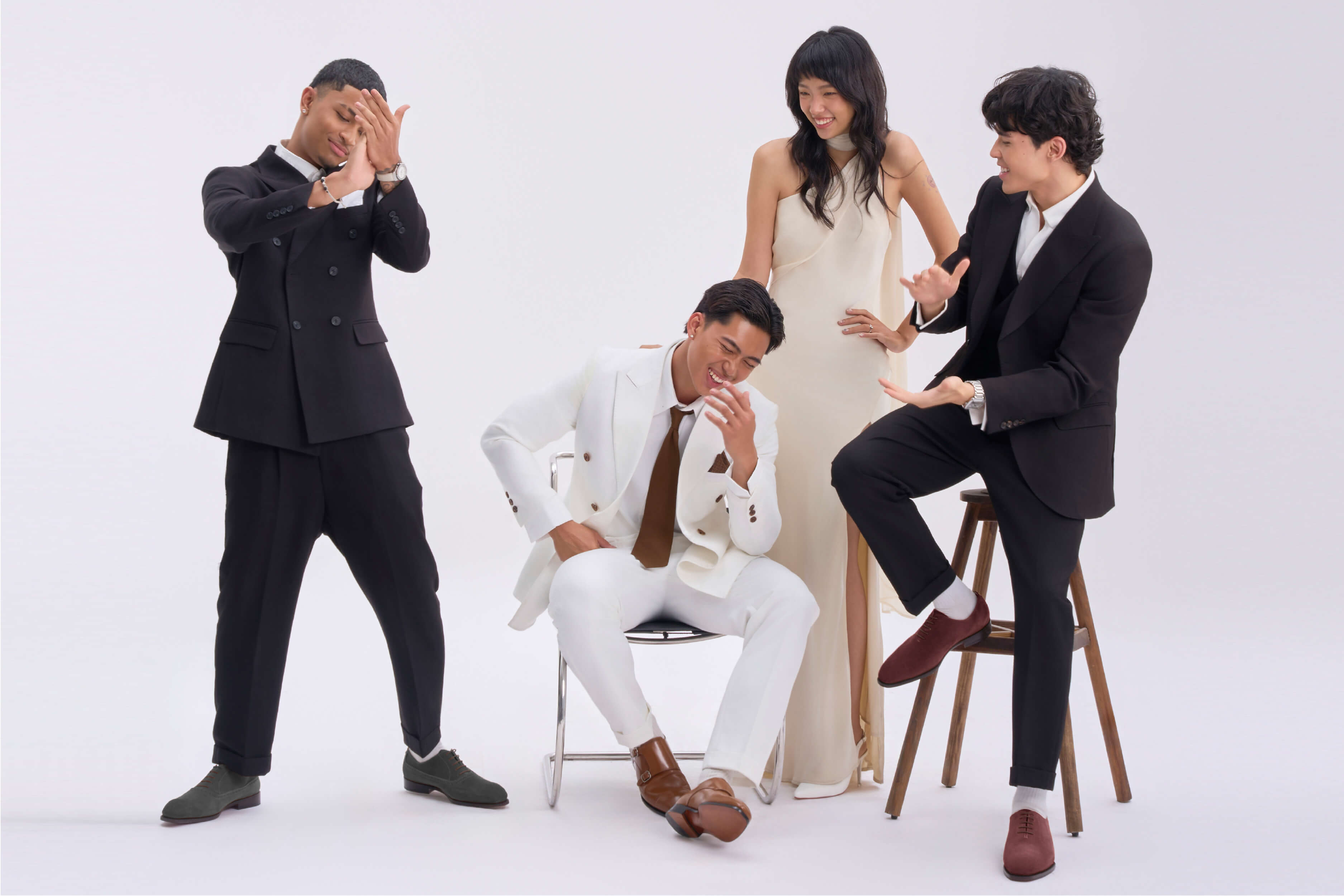 A groom wearing light brown double-monkstrap Oxford shoes with a white suit A groom wearing light brown double-monkstrap Oxford shoes with a white suit